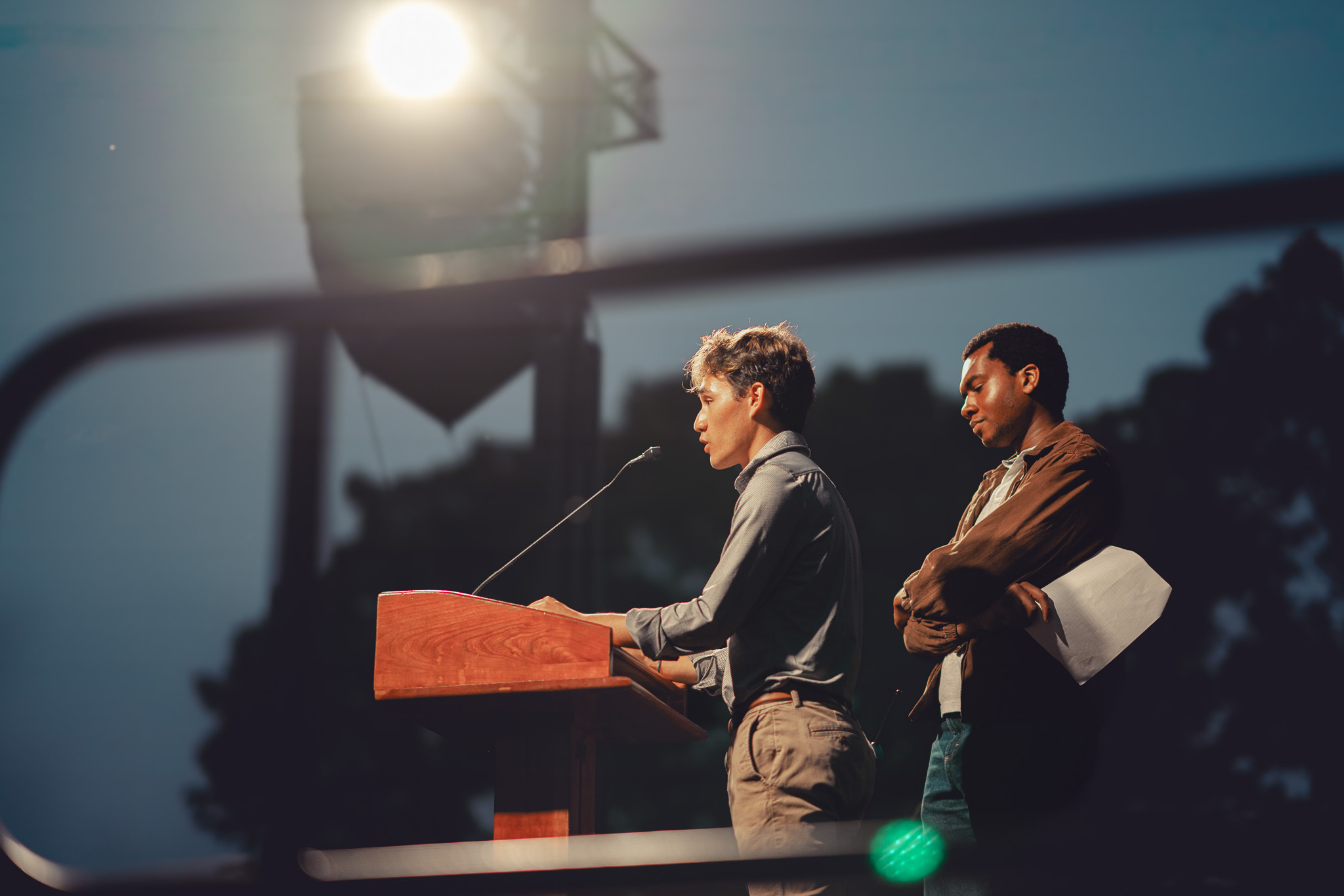 Two students speaking at a podium
